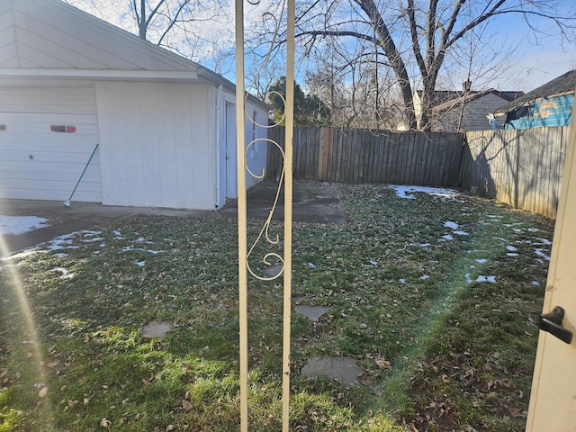 view of yard featuring a garage and a fenced backyard