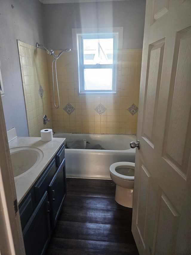 bathroom featuring tub / shower combination, vanity, toilet, and wood finished floors