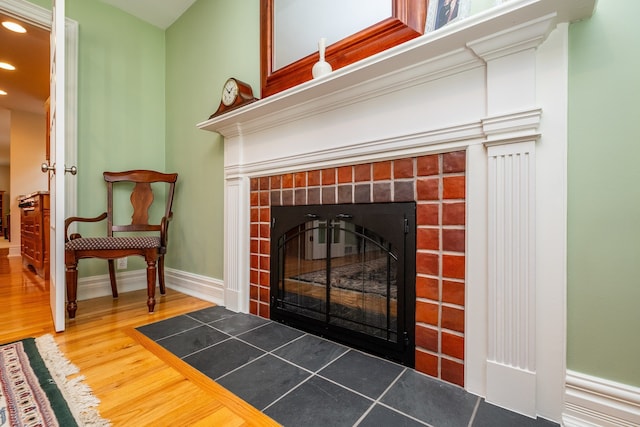 details with a fireplace with flush hearth, baseboards, wood finished floors, and recessed lighting