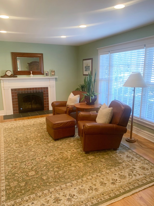 living room with a fireplace, wood finished floors, and recessed lighting