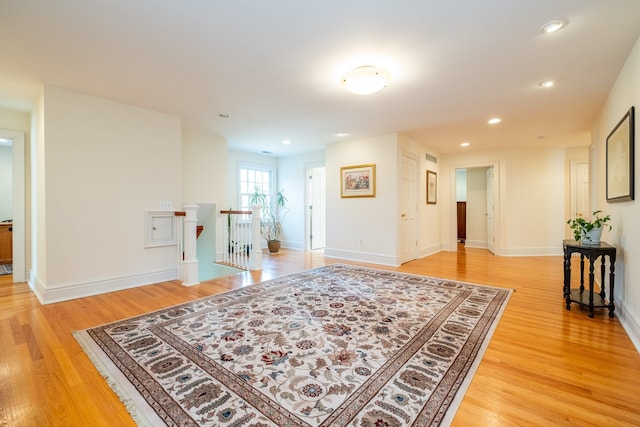 interior space with baseboards, light wood-style flooring, and recessed lighting