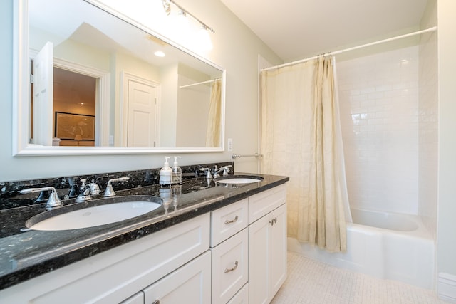 full bath with double vanity, shower / bathtub combination with curtain, a sink, and tile patterned floors