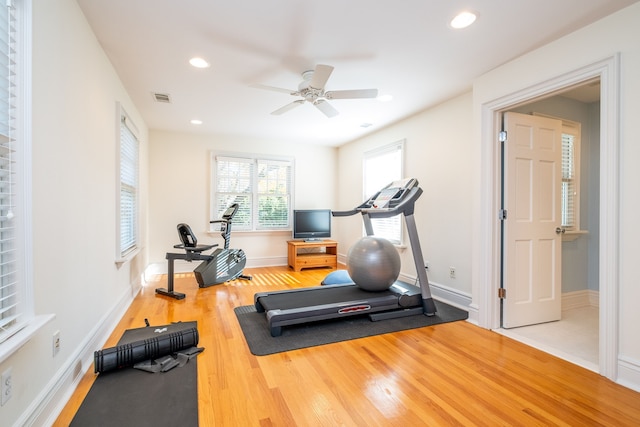 workout area featuring baseboards, visible vents, wood finished floors, and recessed lighting