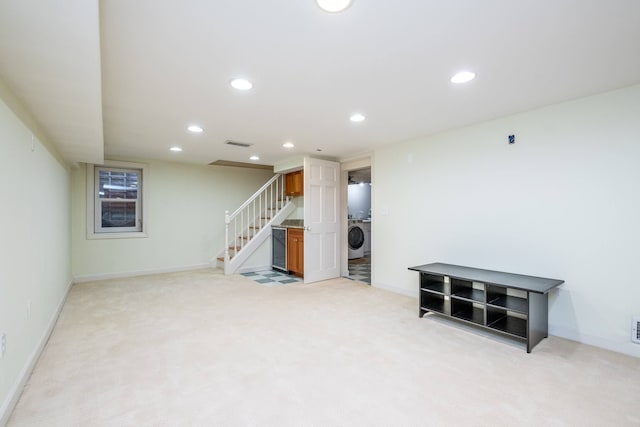 finished below grade area with stairway, recessed lighting, washer / clothes dryer, and light colored carpet