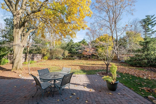 view of patio featuring outdoor dining area and fence