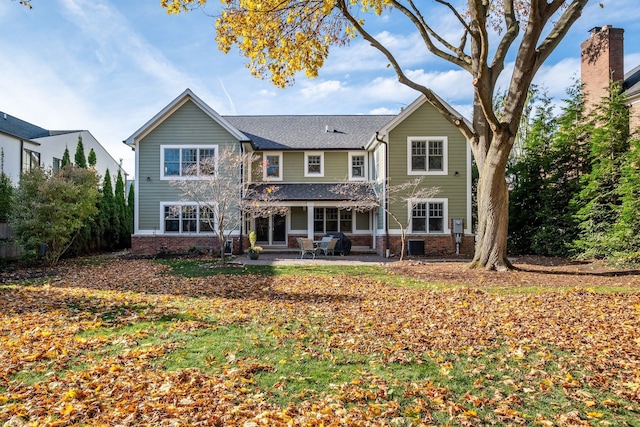 back of property with a patio and brick siding