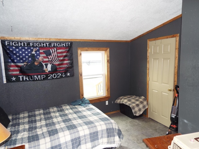 bedroom featuring lofted ceiling and a textured ceiling