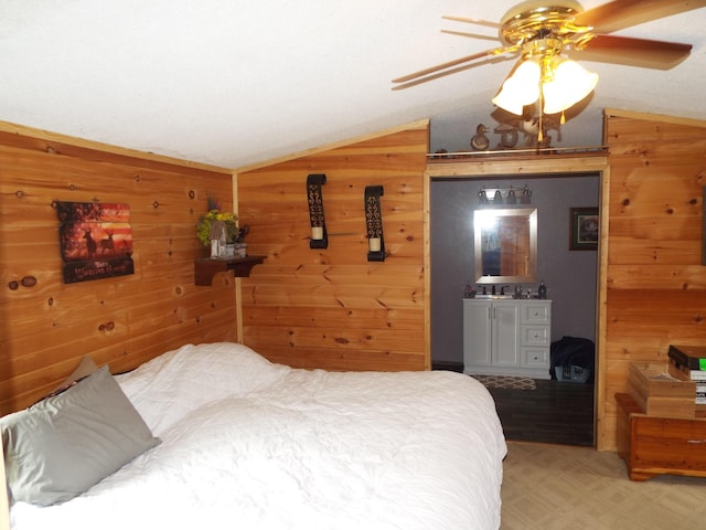 bedroom featuring lofted ceiling, wood walls, and a ceiling fan