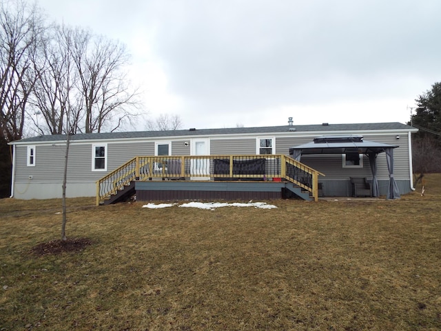 back of house featuring a yard, a wooden deck, and stairs