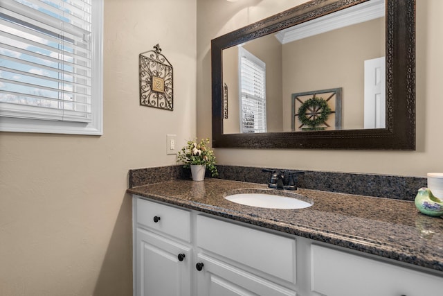 bathroom with vanity and ornamental molding