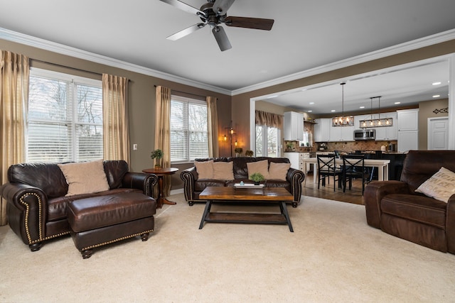 living area with recessed lighting, crown molding, and ceiling fan with notable chandelier