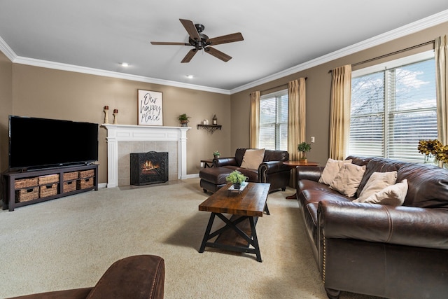 carpeted living area featuring crown molding, baseboards, a tile fireplace, and ceiling fan