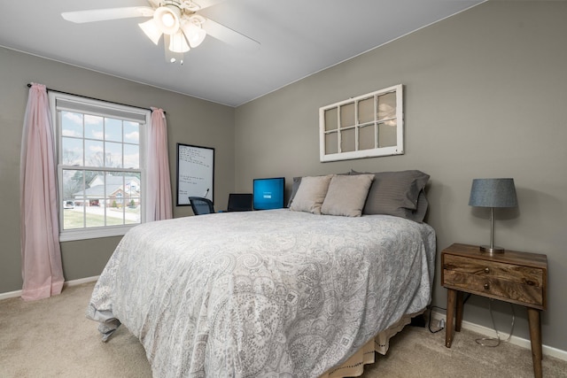 bedroom with baseboards, light colored carpet, and a ceiling fan