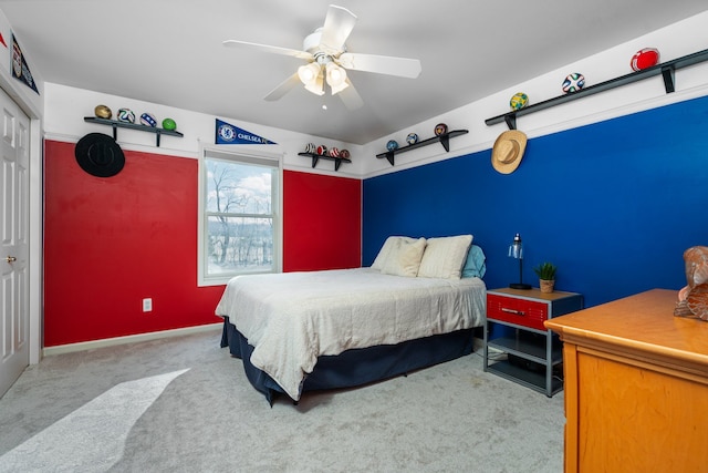 bedroom with a closet, carpet flooring, baseboards, and a ceiling fan