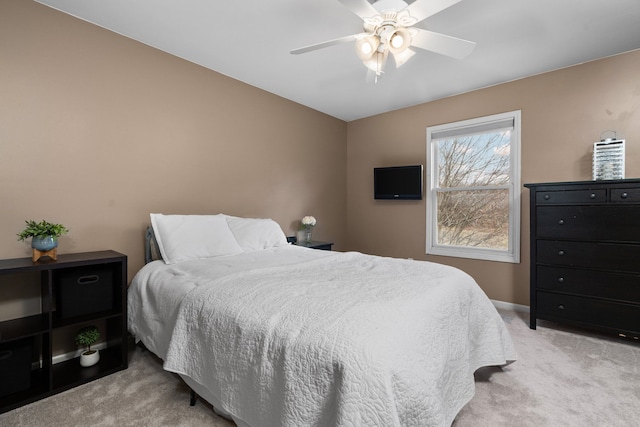 bedroom with ceiling fan and light carpet