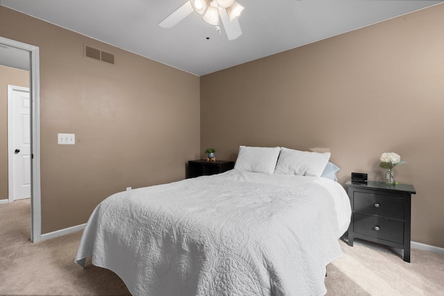 bedroom with visible vents, light carpet, baseboards, and a ceiling fan