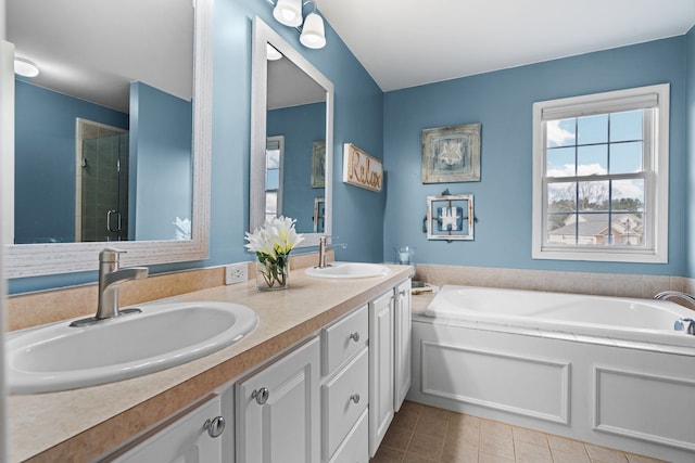 full bath with tile patterned floors, a garden tub, a stall shower, and a sink