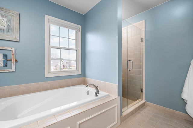 full bath featuring tile patterned flooring, a bath, and a stall shower