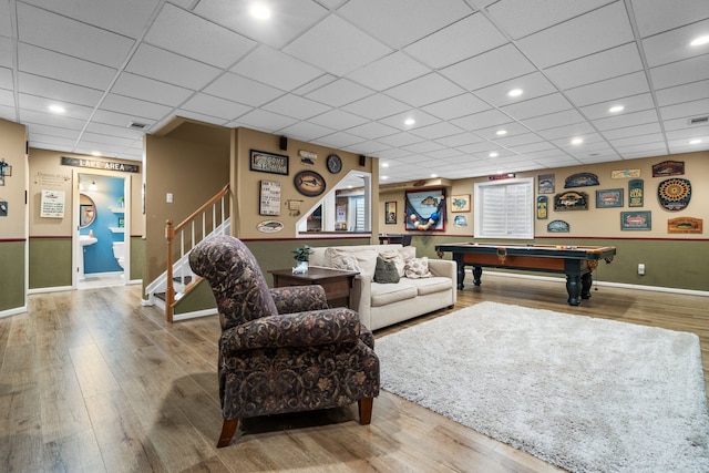 living room featuring billiards, stairway, and wood finished floors