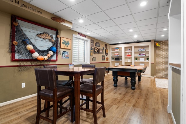 recreation room with a drop ceiling, baseboards, pool table, and light wood finished floors