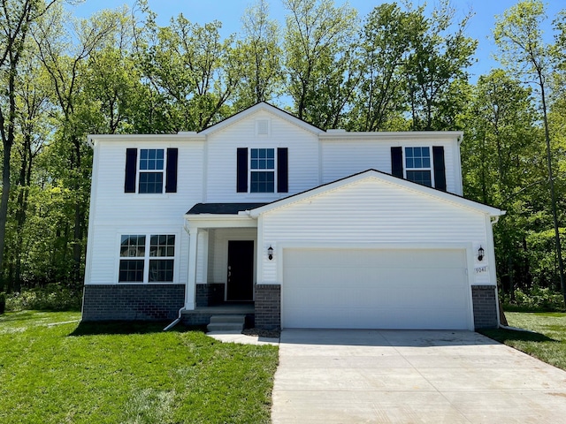 view of front of property with a garage, driveway, a front yard, and brick siding