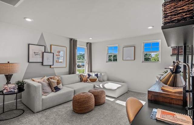 living area featuring baseboards, visible vents, and recessed lighting