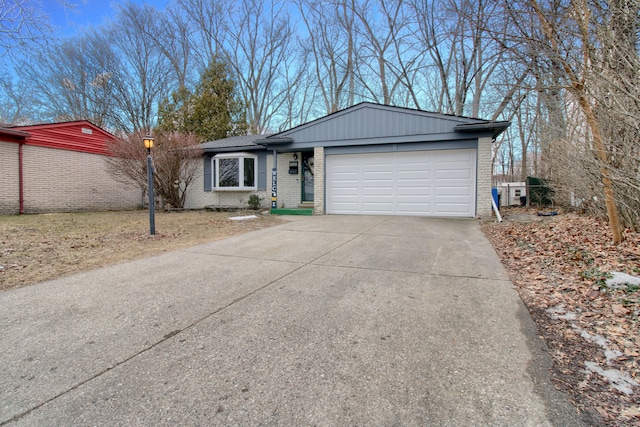 ranch-style house featuring a garage, driveway, and brick siding