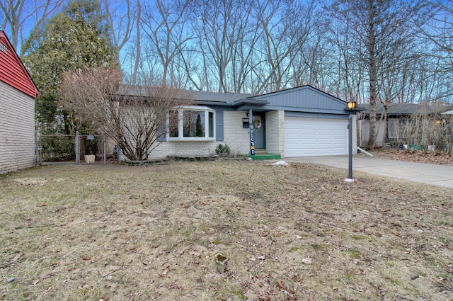 single story home featuring driveway, brick siding, an attached garage, fence, and a front yard