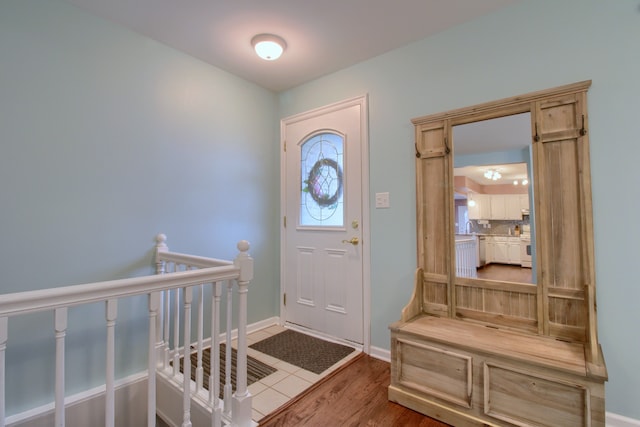 entryway featuring baseboards and wood finished floors