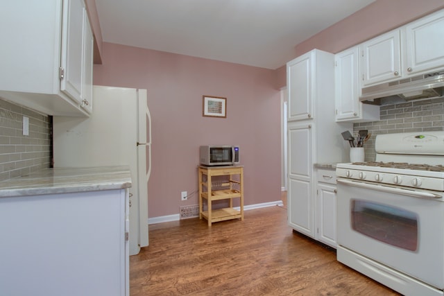 kitchen with light wood-style flooring, under cabinet range hood, white appliances, white cabinetry, and light countertops