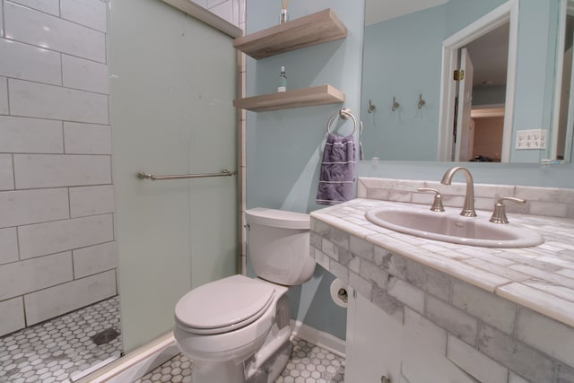 full bathroom with vanity, a shower stall, toilet, and tile patterned floors