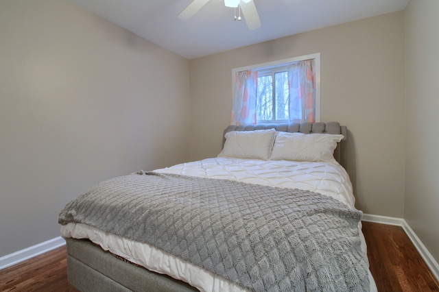 bedroom featuring dark wood finished floors, a ceiling fan, and baseboards