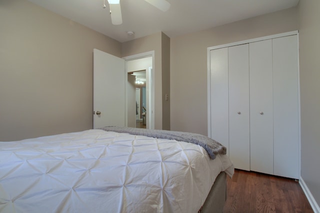 bedroom with a closet, wood finished floors, and a ceiling fan