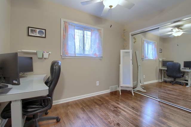 office area featuring a healthy amount of sunlight, visible vents, and wood finished floors