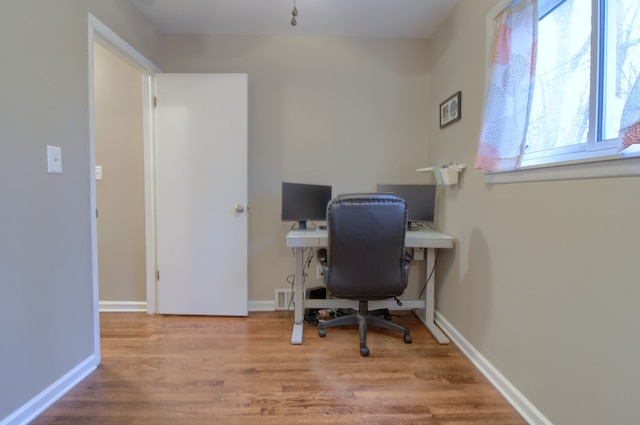 office with baseboards and wood finished floors