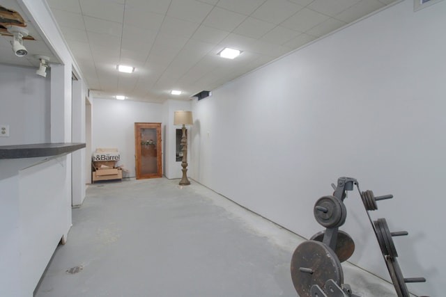 exercise room with a paneled ceiling