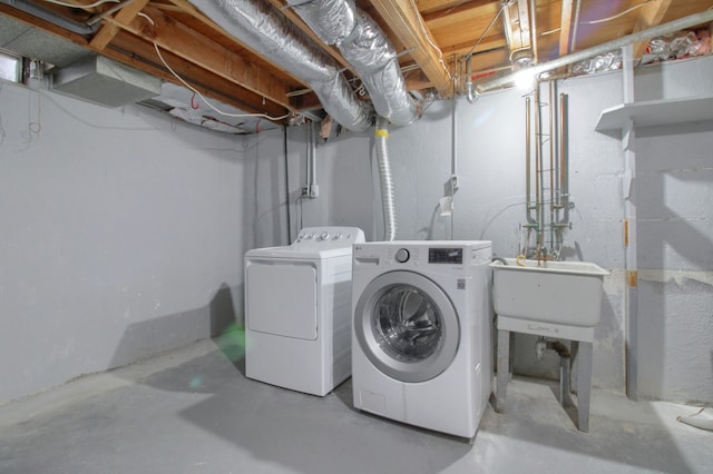 laundry room featuring laundry area, independent washer and dryer, and a sink