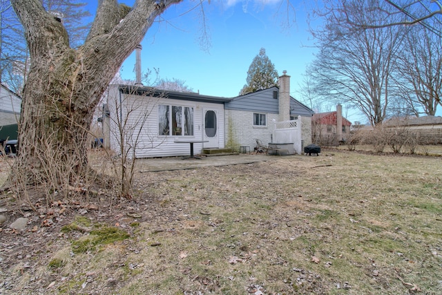 back of house with a chimney