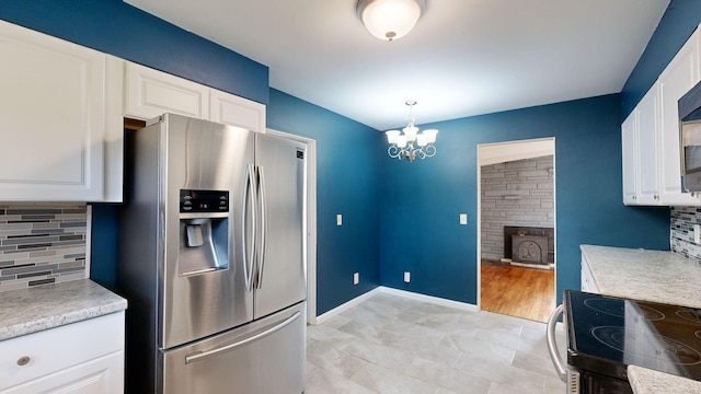 kitchen with tasteful backsplash, light countertops, and stainless steel fridge with ice dispenser