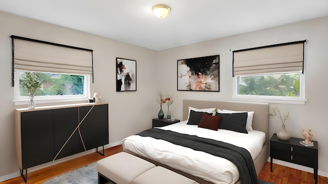 bedroom featuring baseboards and wood finished floors