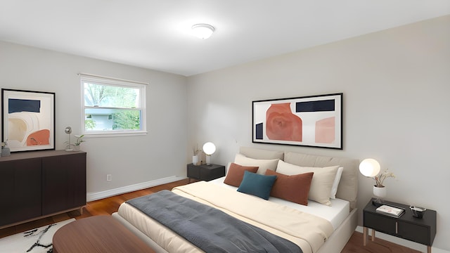 bedroom with wood finished floors and baseboards