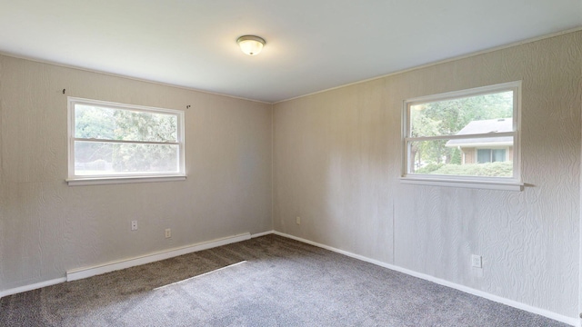 unfurnished room featuring a textured wall, carpet, a baseboard radiator, and baseboards