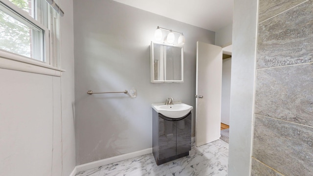 bathroom featuring marble finish floor, baseboards, and vanity