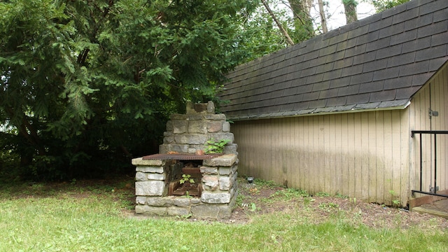 view of outdoor structure with a fireplace