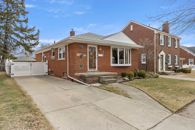 view of front of home featuring brick siding, a chimney, fence, and a gate