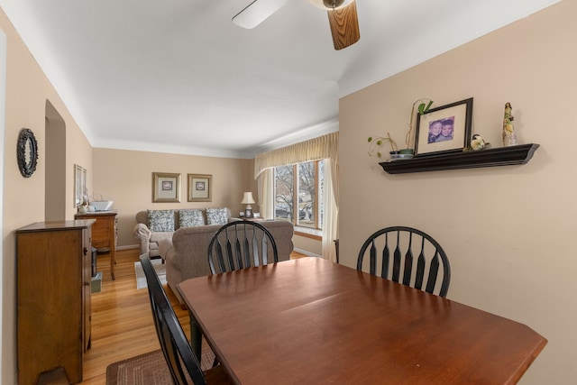 dining area featuring light wood-type flooring, ceiling fan, and baseboards