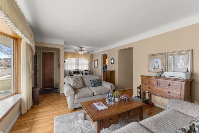 living area featuring baseboards and light wood-style floors