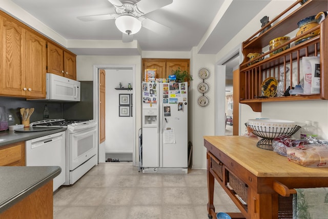 kitchen featuring white appliances, brown cabinetry, dark countertops, ceiling fan, and open shelves