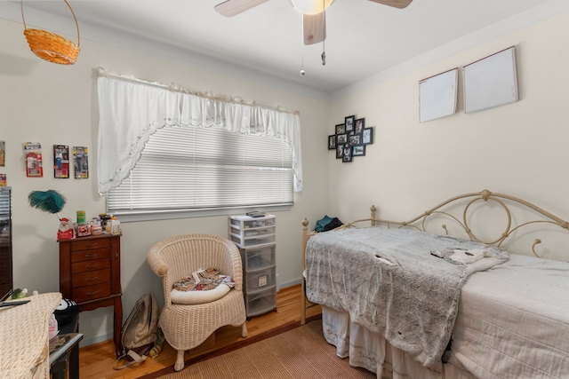 bedroom with wood finished floors and a ceiling fan