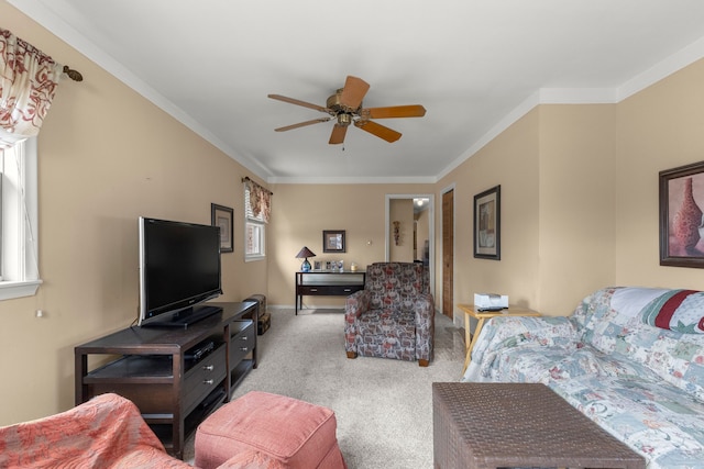 carpeted living room with ceiling fan, ornamental molding, and baseboards